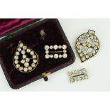 A CASED SET OF VICTORIAN PASTE STONE SET BUCKLES, one pear shape set, each measuring approximately