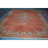 A 20TH CENTURY CHINESE RUSSET CARPET SQUARE with foliate decoration, 314cm x 223cm (sd)
