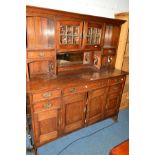 AN EARLY 20TH CENTURY OAK DRESSER, the top with double lead glazed doors above a bevelled edge