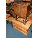 A SMALL CARVED OAK TWO DOOR CABINET, a low pine two drawer chest of drawers, a cane seated chair and