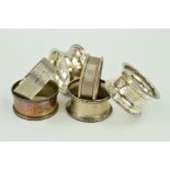 A PAIR OF GEORGE V CIRCULAR SILVER NAPKIN RINGS, Birmingham 1918, together with four other