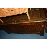 A REPRODUCTION OAK TRIPLE PANEL COFFER, width 125cm x depth 54cm x height 57cm