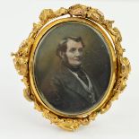 A LATE VICTORIAN GOLD MEMORIAL SWIVEL BROOCH, of oval outline with an over painted photograph of a