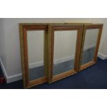 FOUR MODERN FOLIATE GILT FRAMED BEVELLED EDGE WALL MIRRORS, 113cm x 83cm