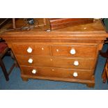 A GEORGIAN OAK AND MAHOGANY CHEST of two short and two long drawers with circular white ceramic