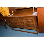 A REPRODUCTION OAK SIDEBOARD with single cupboard doors flaking three drawers, width 127cm x depth