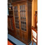 AN OAK LEAD GLAZED TWO DOOR BOOKCASE, width 91cm x depth 32cm x height 186cm