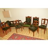 AN EDWARDIAN WALNUT SEVEN PIECE PARLOUR SUITE with buttoned green leather, comprising of a chaise