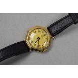A RECORD WRISTWATCH WITH 9CT GOLD HEAD, the octagonal head with Arabic numerals, black leather
