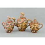A THREE PIECE SATSUMA WARE TEA SERVICE, decorated with dragons and immortals, (lid on sugar