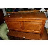 AN OAK DOUBLE PANEL BLANKET CHEST