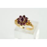 A 9CT GOLD GEM SET RING, designed with a central circular red gem within a circular red gem