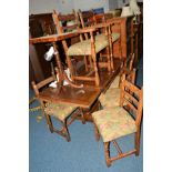 A REPRODUCTION CARVED OAK DRAW LEAF TABLE, on acorn legs united by a stretcher, extended width 213cm