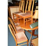 A TEAK OVAL EXTENDING DINING TABLE and eight chairs (9)