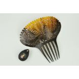 AN EARLY 19TH CENTURY HORN HAIR COMB AND A LATE VICTORIAN BOG OAK PENDANT, the large hair comb