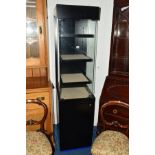 A BLACK PAINTED SHOP DISPLAY CABINET, with triple adjustable shelves above a single cupboard door,