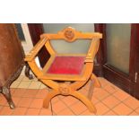 AN OAK SAVONAROLA CHAIR with a single bar back