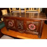 A 20TH CENTURY CARVED OAK BLANKET CHEST, the central panel of a man at a brewery, width 101cm x