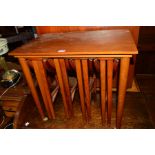 A TEAK NEST OF FOUR TABLE DROP LEAF TABLES