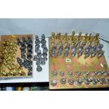 A BRASS AND COPPER CHESSBOARD, with four complete and two incomplete sets of brass and pewter or
