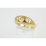 A 9CT GOLD RING, designed as three circular colourless gems assessed as paste, within star settings,