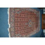 A 20TH CENTURY ABADEH RUG, red and blue ground with a multi strap border, 327cm x 229cm