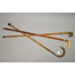 A GEORGE V SILVER MOUNTED WALKING STICK, together with two walking canes (3)