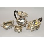 AN EDWARDIAN RECTANGULAR FOUR PIECE SILVER PLATED TEA SET, shell and gadroomed rims (4)