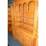 A MODERN LIGHT OAK DRESSER with seven drawers, width 140cm x depth 60cm x height 219cm