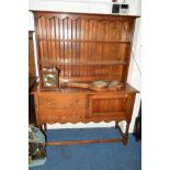 A 20TH CENTURY OAK DRESSER, with two drawers and single cupboard door, width 138cm x depth 151cm x