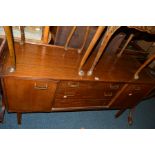 AN E GOMME G PLAN 1950'S TEAK SIDEBOARD, double cupboard doors flanking three drawers, width 145cm x