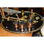 A LARGE OVAL BLACK ENAMELLED AND GILT TRAY, a set of three hay stack measures and other metalware (