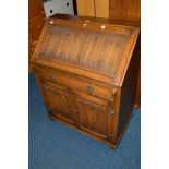 AN OLD CHARM OAK LINENFOLD BUREAU with a single drawer (sd)