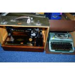 A CASED SINGER SEWING MACHINE, black cast box with gold decoration, with drawer to wooden base,
