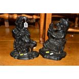 A PAIR OF PAINTED CAST IRON PUNCH AND JUDY DOOR STOPS