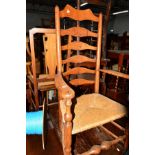A 19TH CENTURY OAK AND ELM RUSH SEATED LADDER BACK ELBOW CHAIR, together with three various