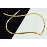 A NECKLACE, designed as a V-shape flattened chain to the hook and push piece clasp, stamped 10Kt,