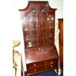 AN EDWARDIAN MAHOGANY BUREAU BOOKCASE, the flanked canted top above double astragal glazed doors,