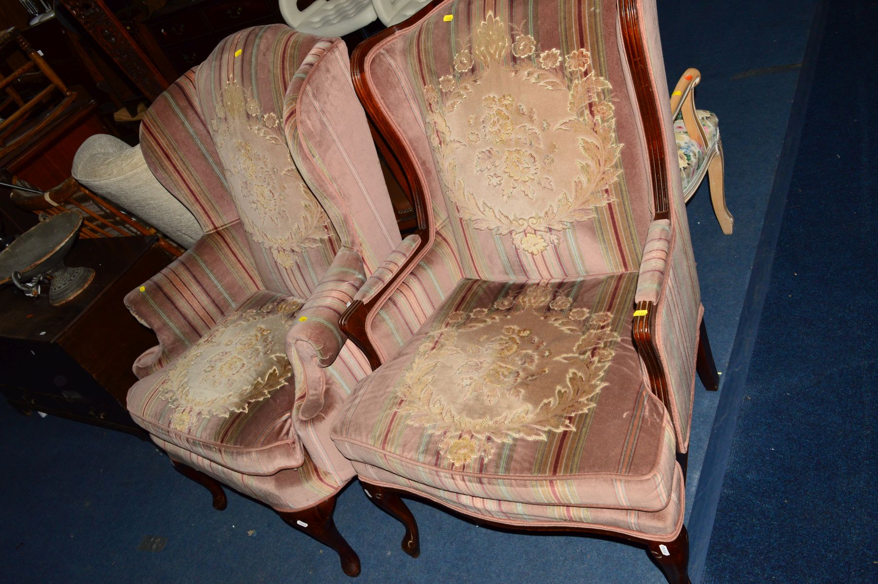 A STRIPPED PINK UPHOLSTERED WING BACK ARMCHAIR, on cabriole legs, together with a matching