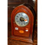 AN EDWARDIAN MAHOGANY AND BANDED BULLE ELECTRIC MANTEL CLOCK, with a silvered 15cm diameter dial,