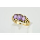 A LATE 20TH CENTURY 9CT GOLD THREE STONE AMETHYST RING, scroll engraved sides and shoulders, rings