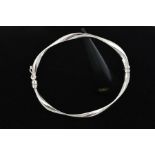 A 9CT WHITE GOLD HINGED BANGLE, the twisted design with a sprung hinge and figure of eight clasp,