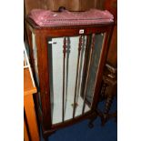 AN EDWARDIAN MAHOGANY GLAZED SINGLE DOOR CHINA CABINET, on ball and claw feet