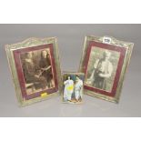 A PAIR OF EDWARDIAN SILVER PLATED PHOTOGRAPH FRAMES, embossed with ribbons, swags and foliate
