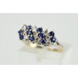 A 9CT WHITE GOLD SAPPHIRE AND DIAMOND DRESS RING, designed as three rows of alternating circular