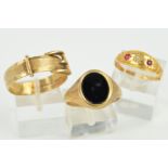 THREE RINGS, the first a signet ring with an oval onyx panel, size S, the second a buckle ring