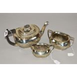 A LATE VICTORIAN SILVER THREE PIECE TEA SERVICE, of oval form, gadrooned rims, reeded decoration,