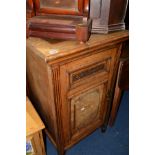 AN EDWARDIAN OAK PANELLED SINGLE DOOR CUPBOARD, revealing two slides, width 60cm x depth 60cm x