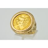 A HALF SOVEREIGN RING, the 1911 half sovereign within a collet mount to the textured and pierced