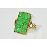 A 9CT GOLD JADE RING, designed as a rectangular carved panel of jade within a rectangular collet